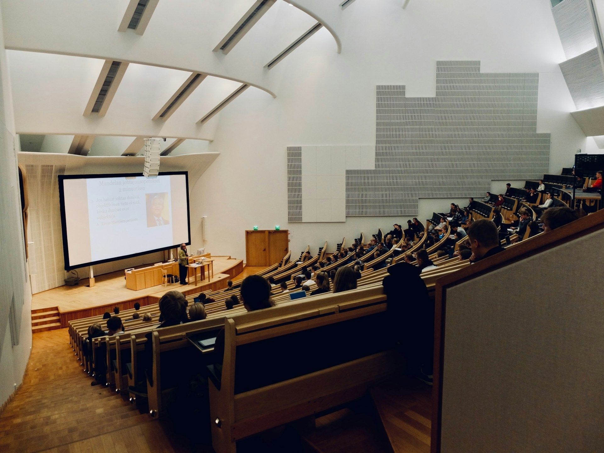 Students sitting in a classroom (Image via Unsplash/Dom Fou)