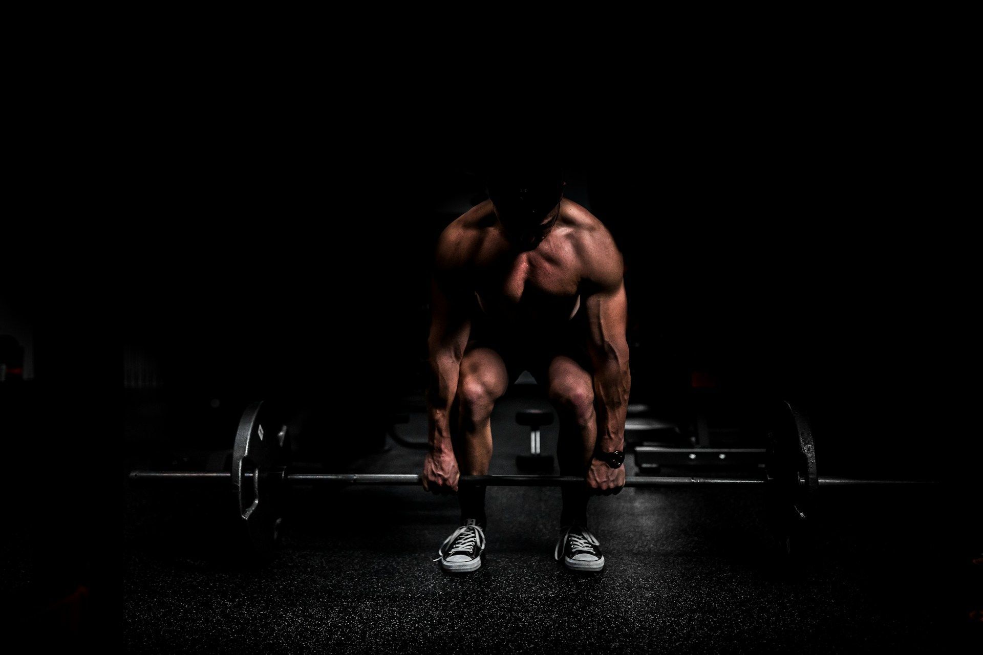 Man lifting weight in gym (Via Unsplash/Anastase Maragos)