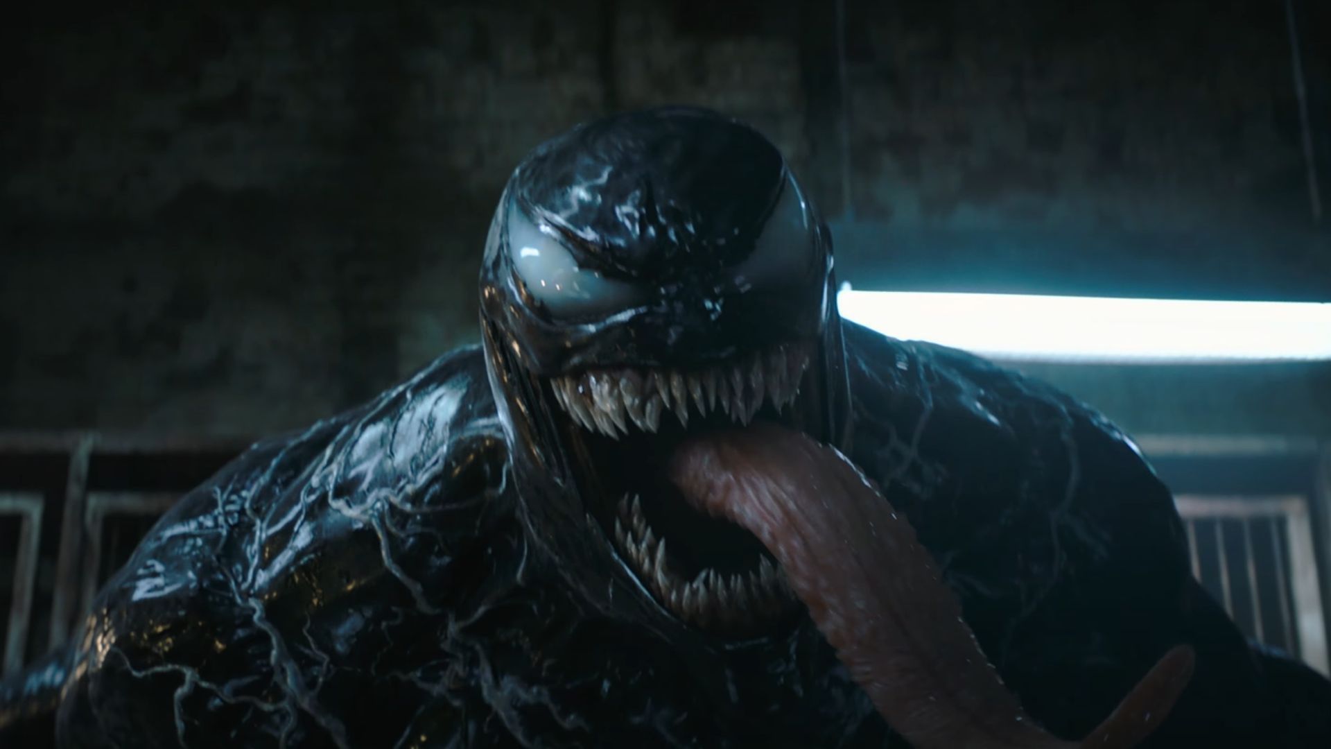 Venom screams as his large tongue hangs out of his mouth.