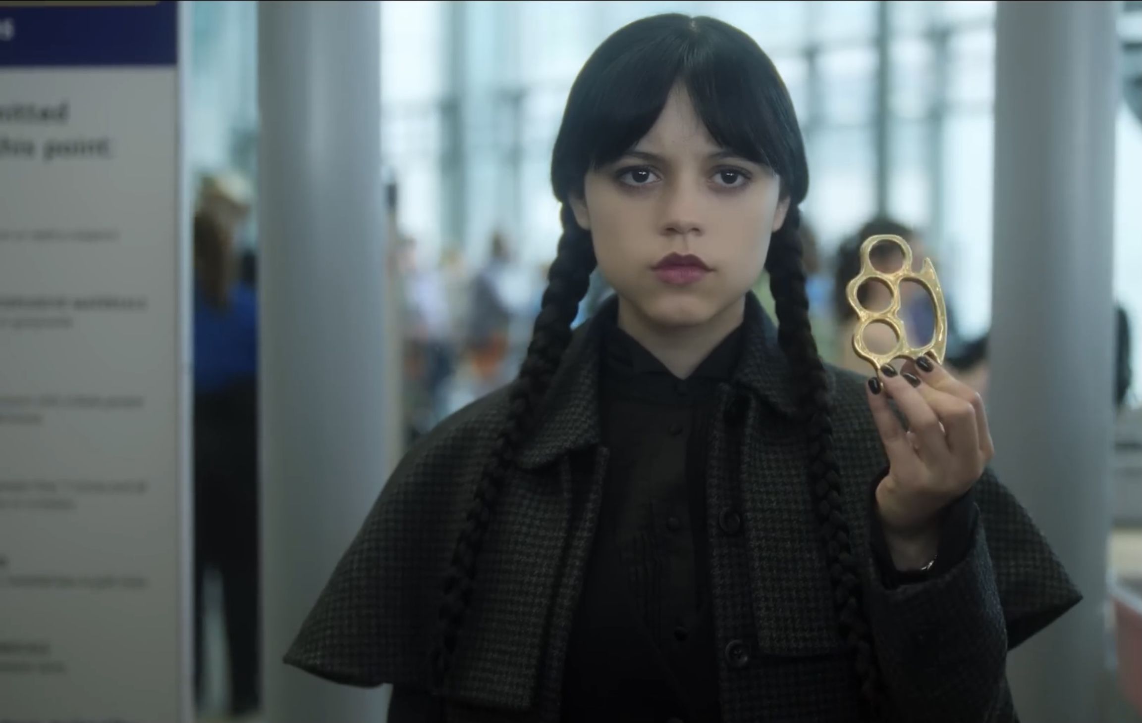 Wednesday showing the brass knuckles | Image va: Netflix on You Tube