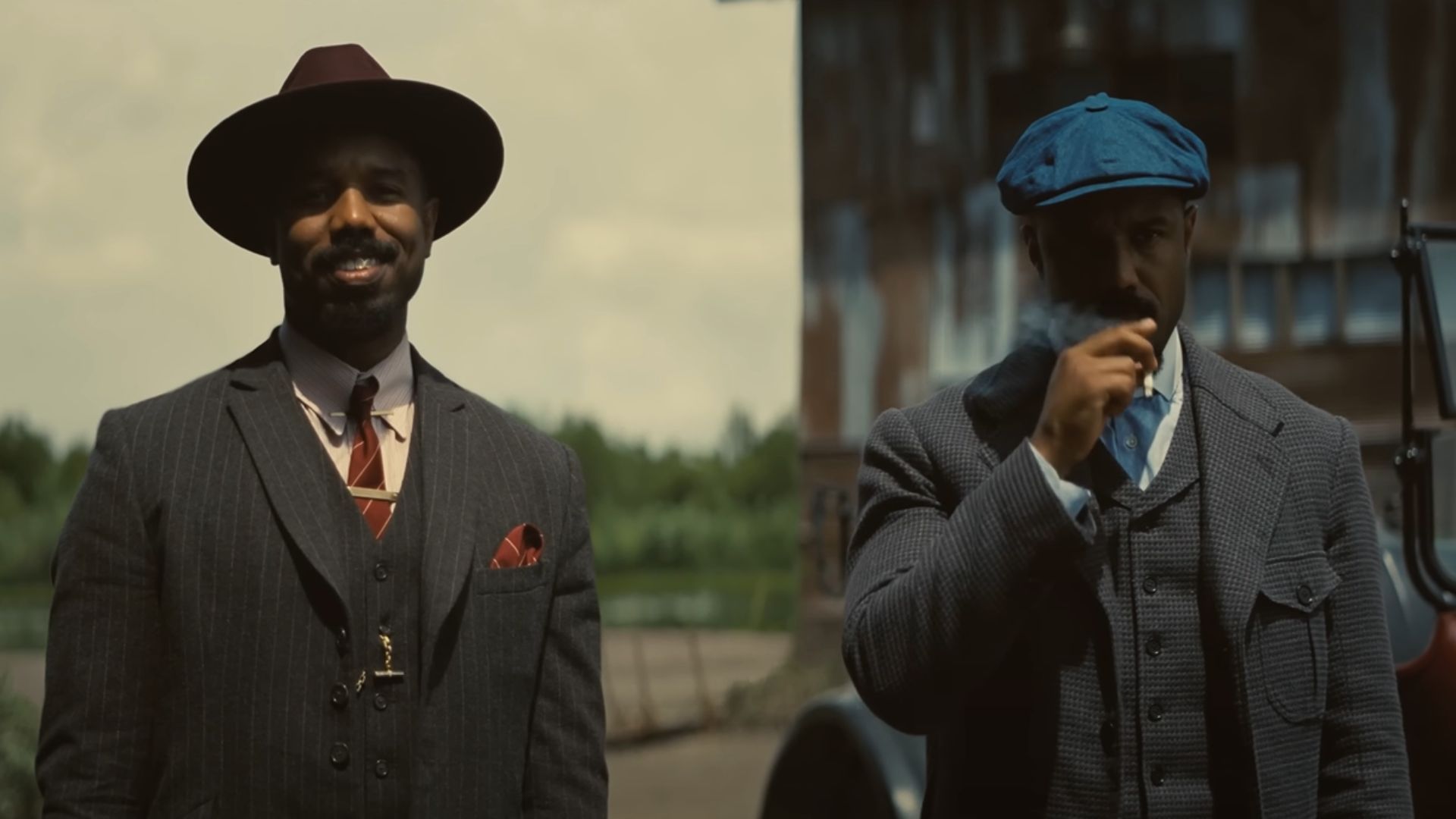 Smoke and Stack standing side by side, one smiling and other