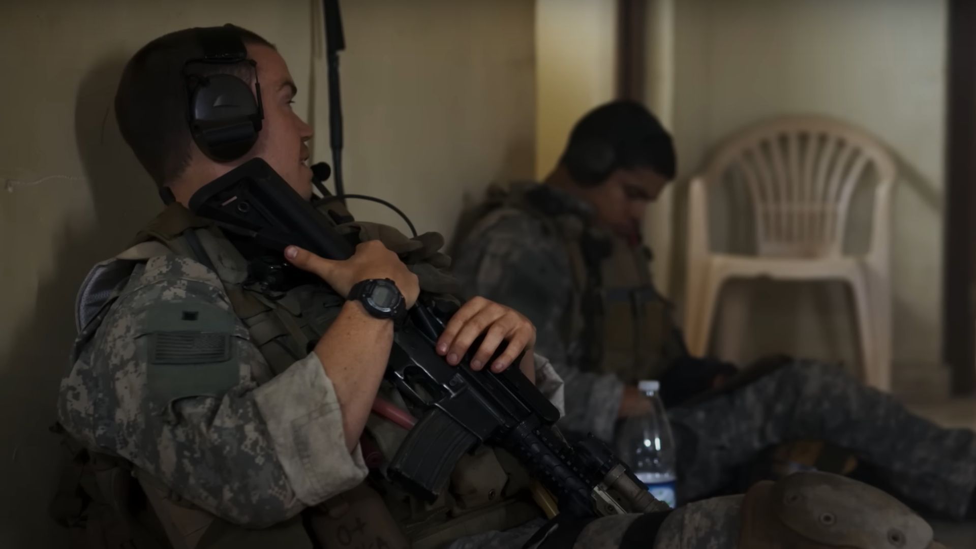 A couple of soldiers sits and chats