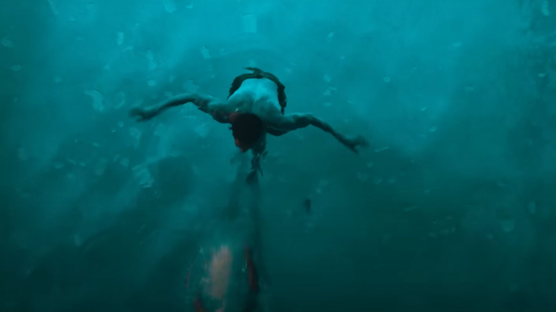 A boy swimming in a swimming pool