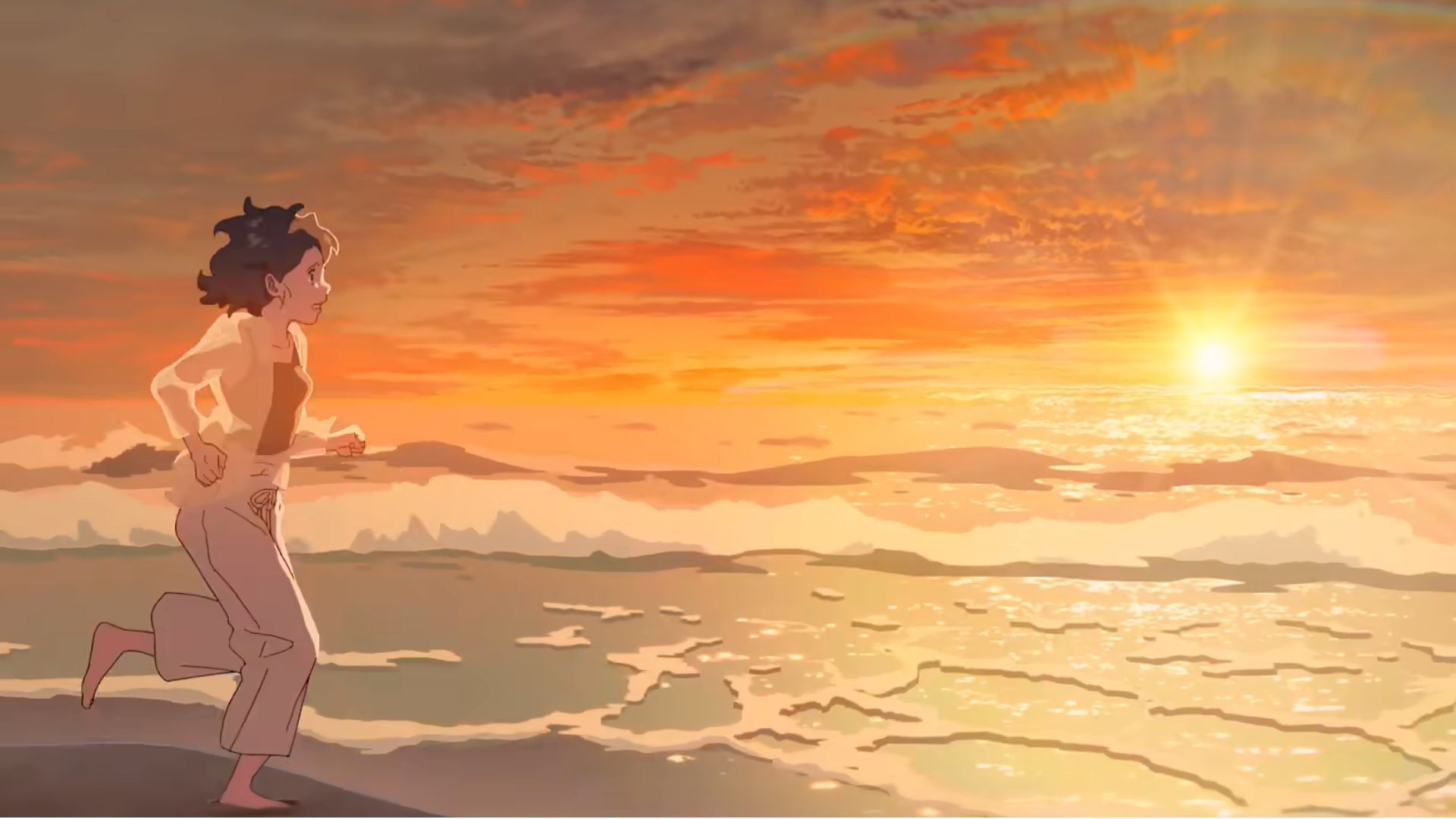 A girl running on a beach with setting sun in the background