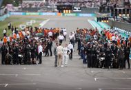 Brad Pitt, star of the upcoming Formula One based movie, Apex, and Javier Bardem talk on the grid during the F1 Grand Prix of Great Britain at Silverstone - Source: Getty