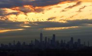 Sunrise in New York City as seen from Kearny, New Jersey. (Image via Getty)