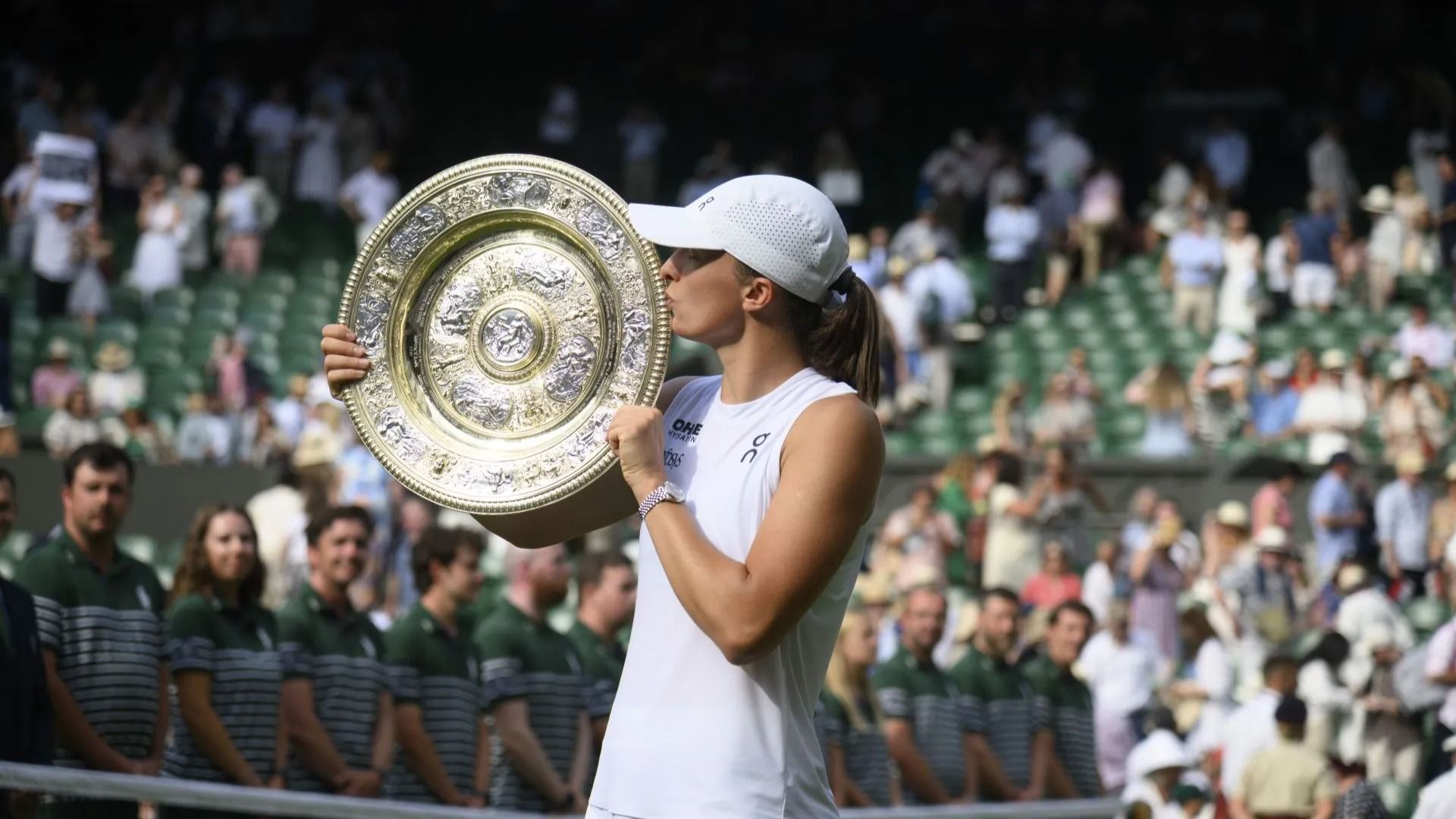Iga Swiatek of Poland holds the Venus Rosewater Dish after winning the Ladies
