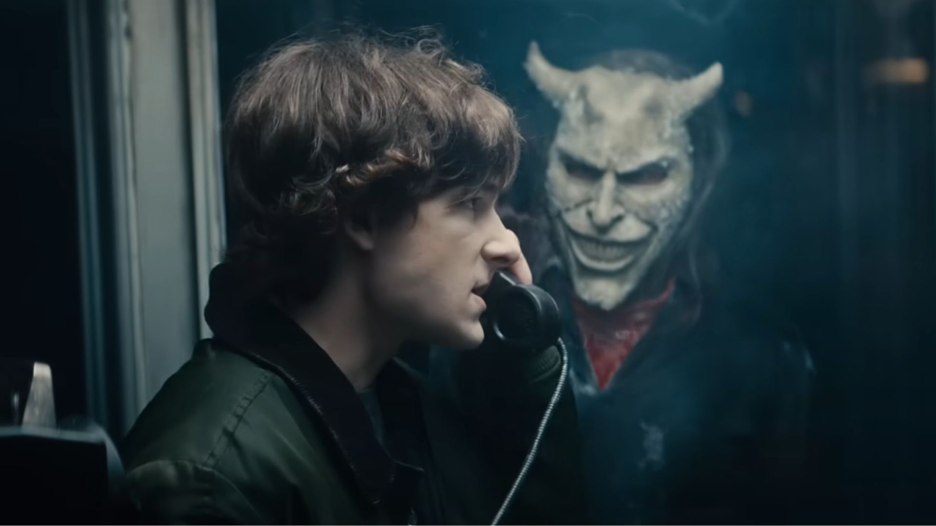 Finney holding a phone