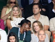 Margot Robbie and husband Tom Ackerley at Center Court Wimbledon 2024 - Day 12. Image via Getty.
