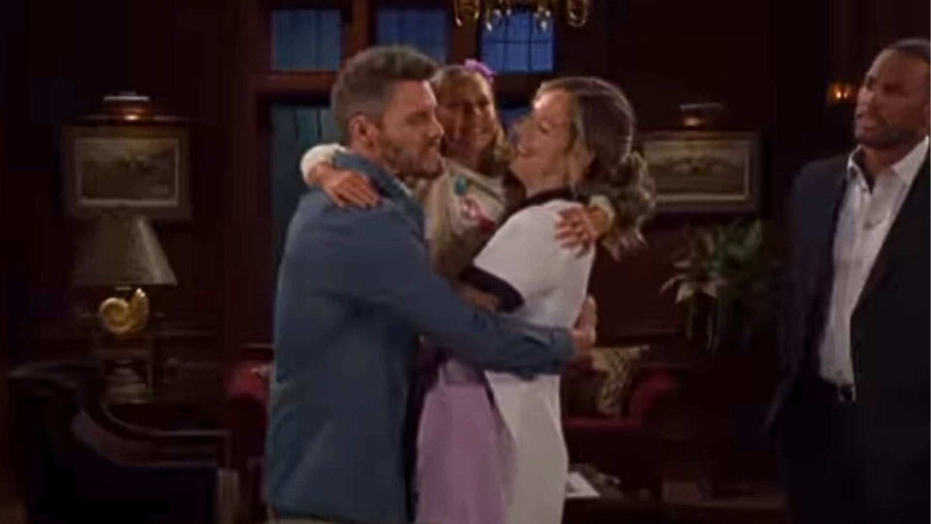 Carter watches uncomfortably as Liam, Hope, and Beth hug | Image: CBS