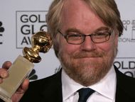 Philip Seymour Hoffman with his Golden Globe Award for Best Performance by an Actor in a Motion Pic (Image via Getty)