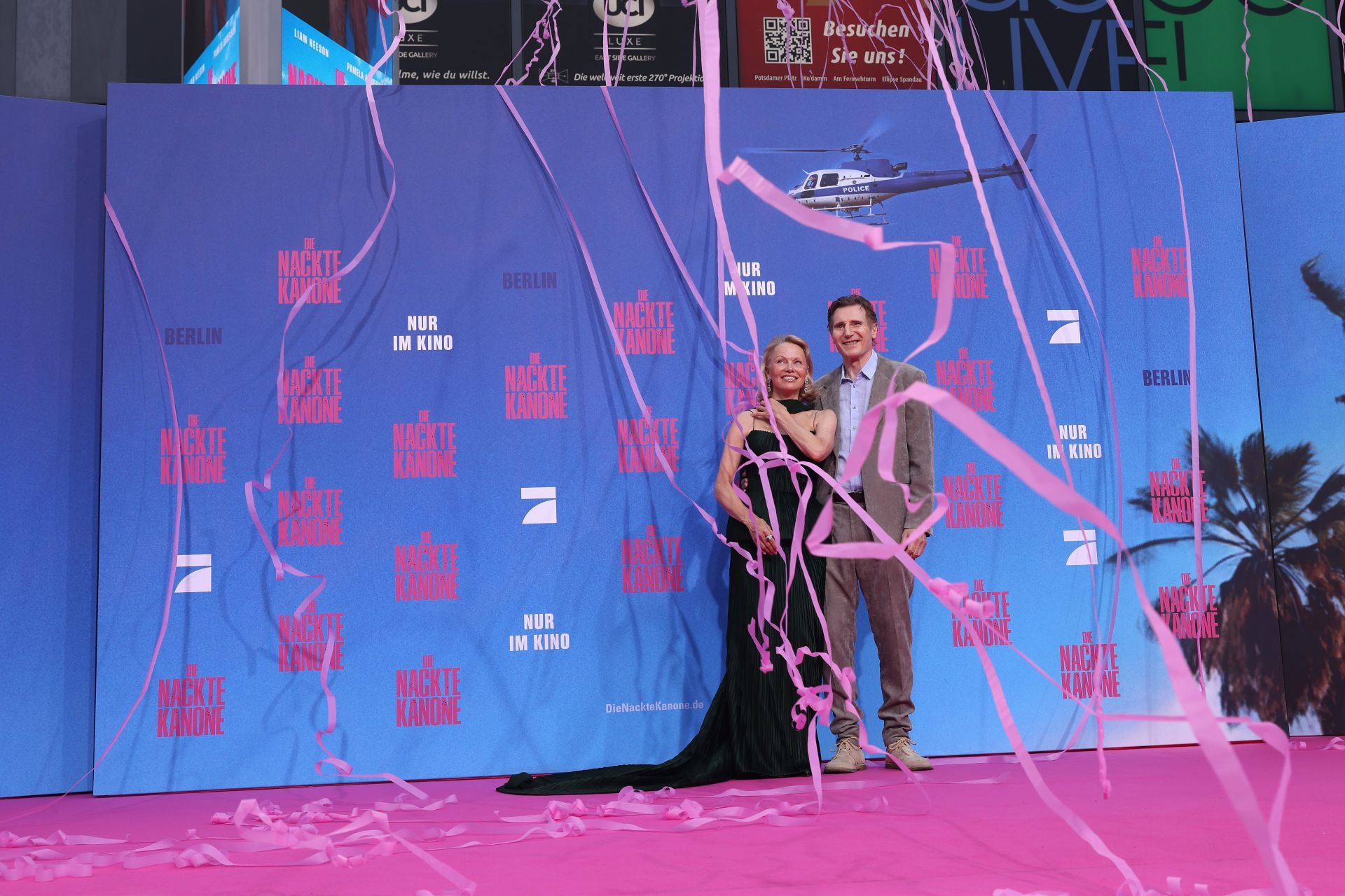 Pamela Anderson and Liam Neeson pose together on the red carpet for &quot;The Naked Gun&quot; German Premiere. Image via Getty.