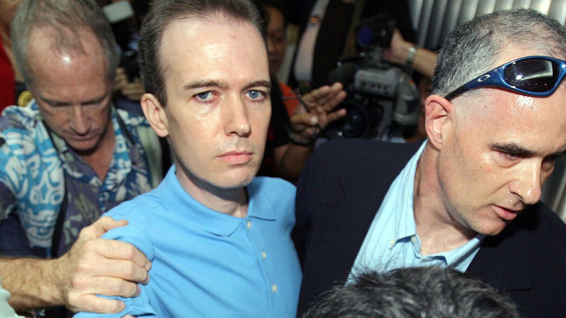 U.S. officials escorted John Mark Karr in Bangkok on August 17, 2006 | Image via NBC