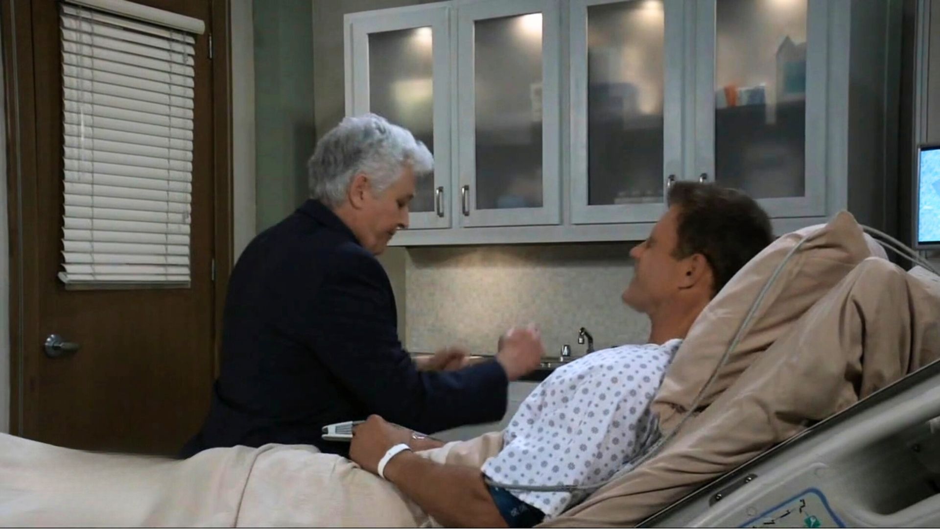 Martin comically plopped down on Drew&#039;s bed, causing him to wince in pain on General Hospital | Image: ABC