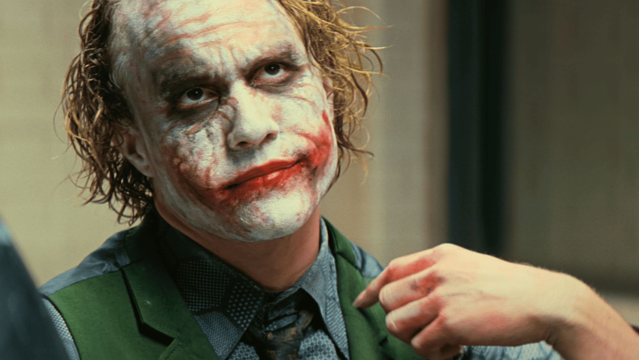 The Joker and Bruce Wayne mirror one another in the penthouse scenes (Image via Warner Bros. Pictures)