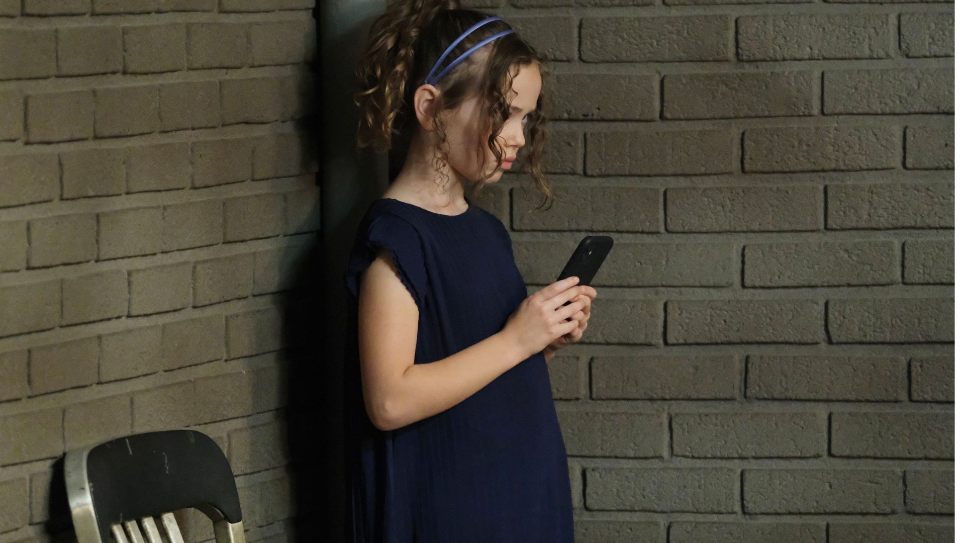 Rachel in the corner on a phone | Image: JPI