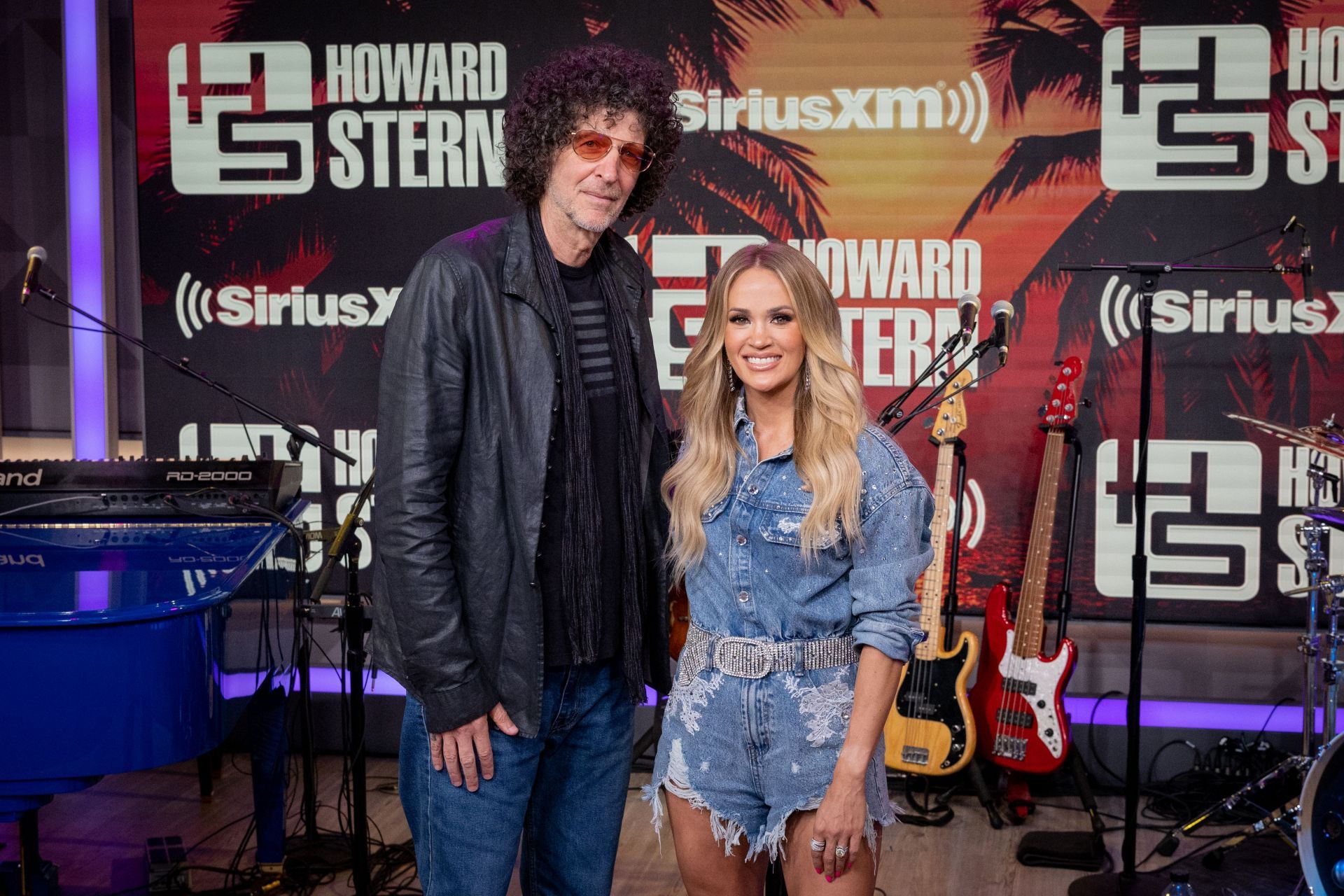 Howard Stern (here with Carrie Underwood) is known for his commentary on contemporary pop culture laced with colorful language (Image via Getty)