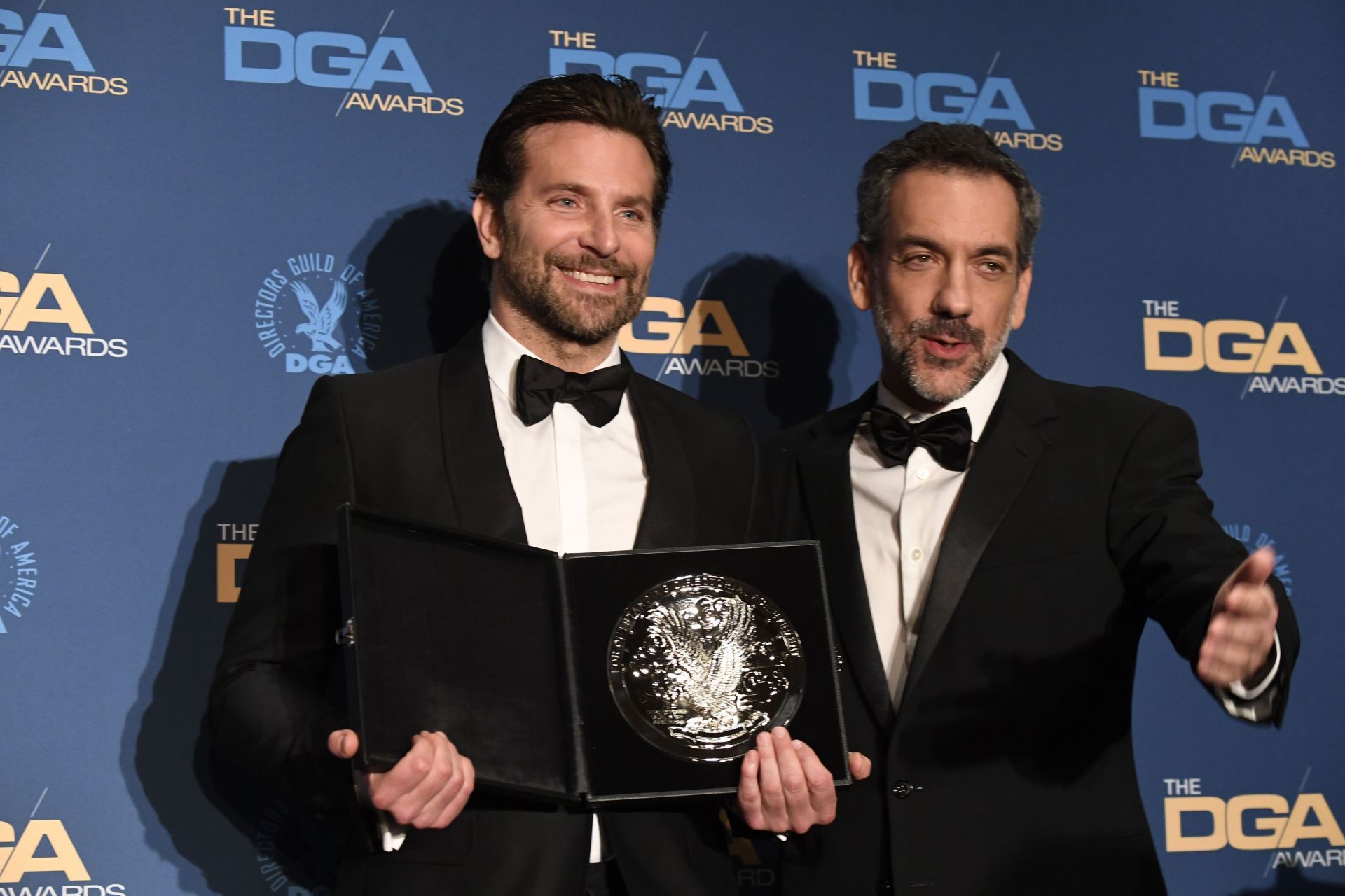  Bradley Cooper (L) and Todd Phillips pose in the pressroom with the award for the Feature Film Nomination for &#039;A Star is Born&#039; Award during the 71st Annual Directors Guild Of America Awards in Hollywood, California | Image via: Getty