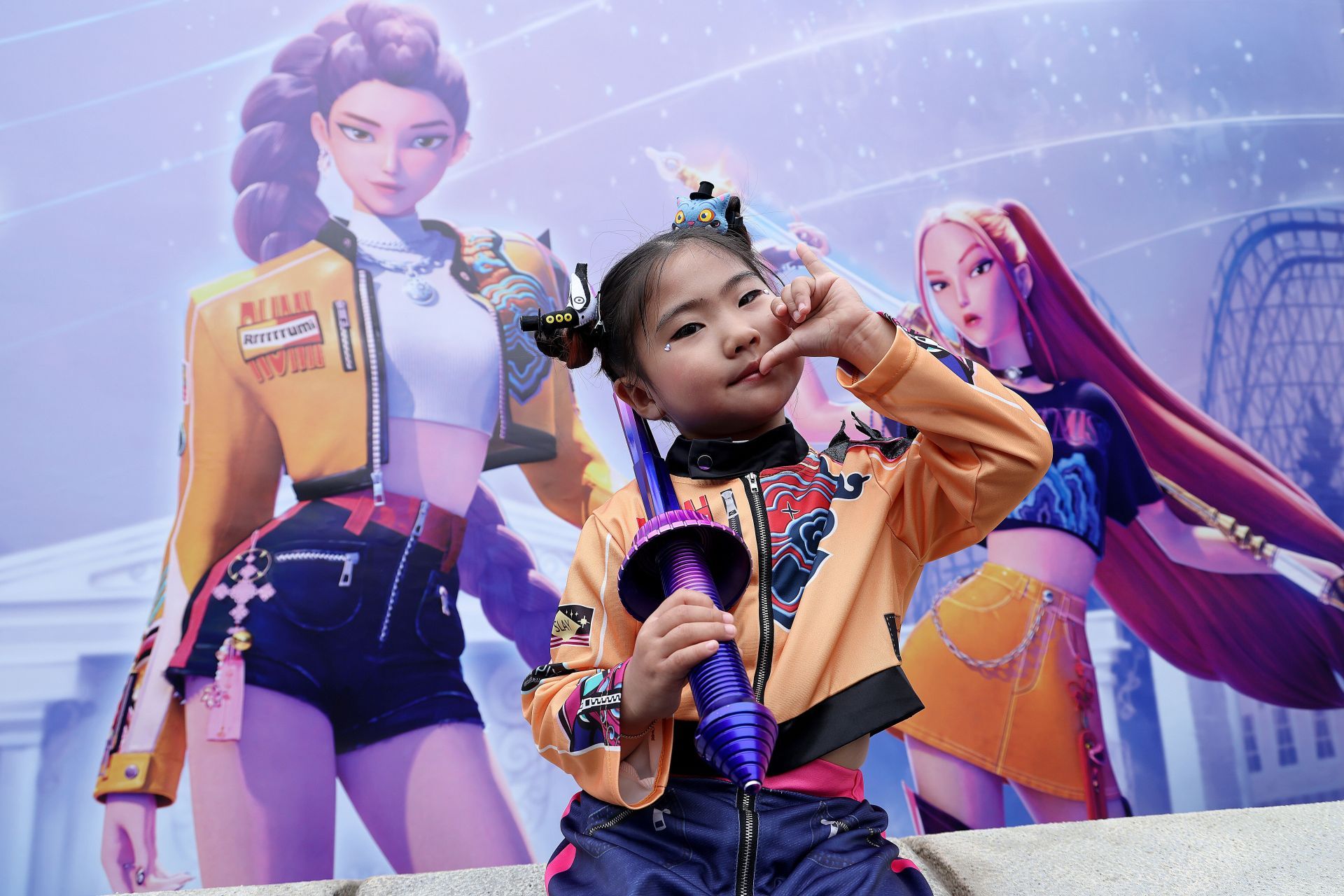 A model wearing a costume based on the charecter Rumi poses for photographs at the KPop Demon Hunters themed zone at Everland on September 30, 2025 in Yongin, South Korea. The park opened a new themed zone on 26 September, in collaboration with Netflix, which features attractions inspired by the animated feature film KPop Demon Hunters | Image via: Getty