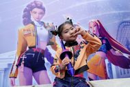 A model wearing a costume based on the charecter Rumi poses for photographs at the KPop Demon Hunters themed zone at Everland on September 30, 2025 in Yongin, South Korea. The park opened a new themed zone on 26 September, in collaboration with Netflix, which features attractions inspired by the animated feature film KPop Demon Hunters | Image via: Getty