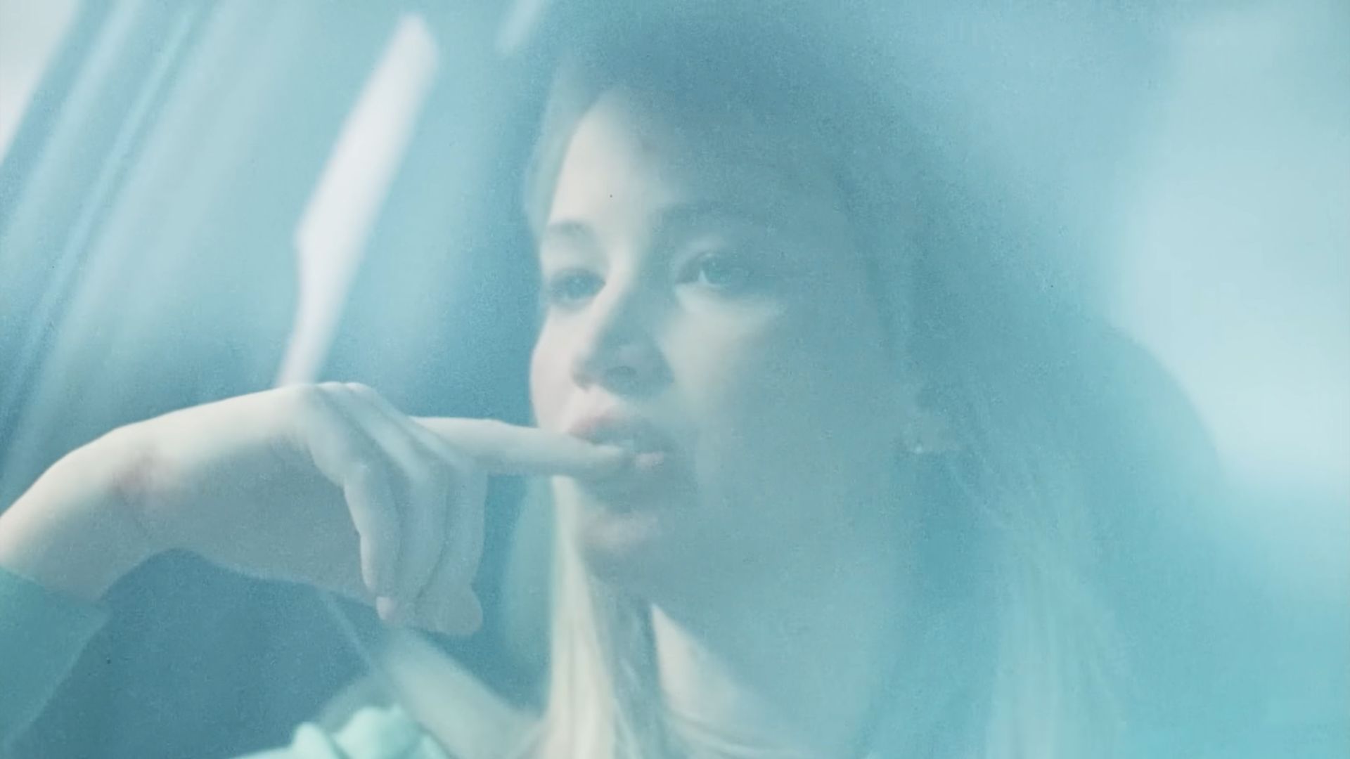 Grace (Jennifer Lawrence) in a car and on a passenger seat, talking