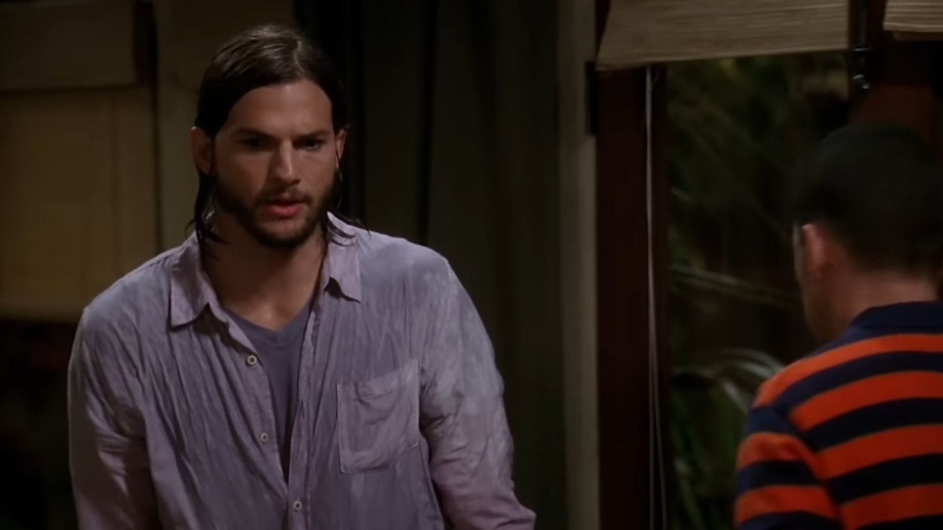 Ashton Kutcher as Walden Schmidt in Two and a Half Men (Image Via YouTube/@Comedy Central UK)