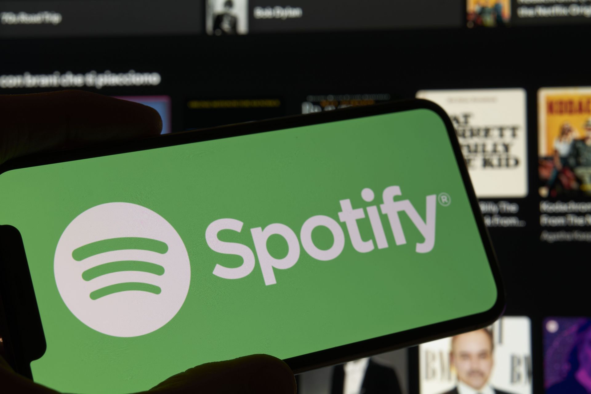 Spotify Logo And App Interface Displayed On Smartphone Screen - Source: Getty